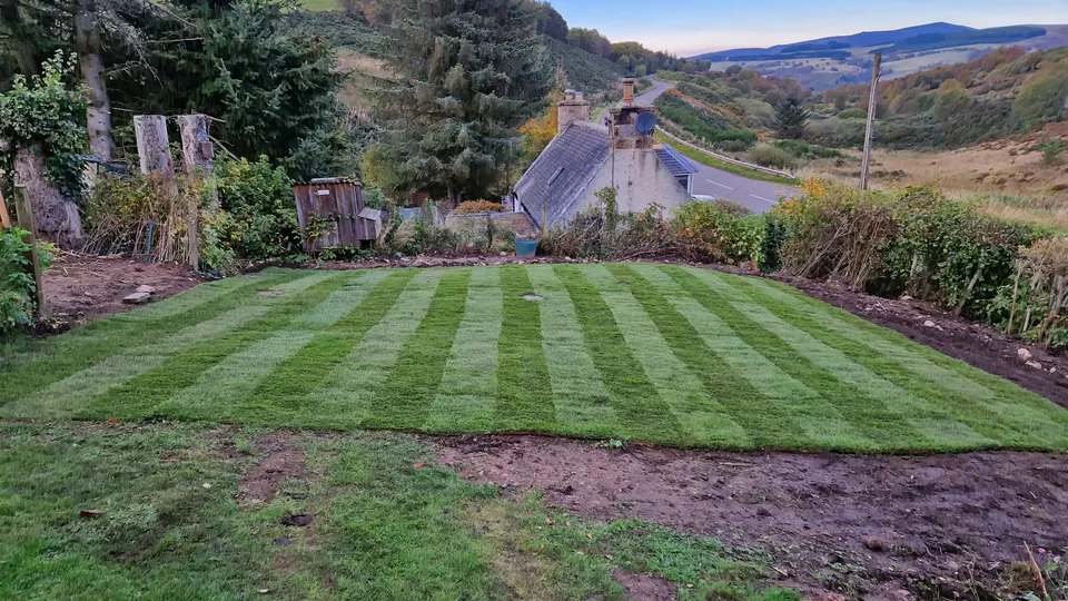 Freshly re-turfed garden overlooking a rural valley